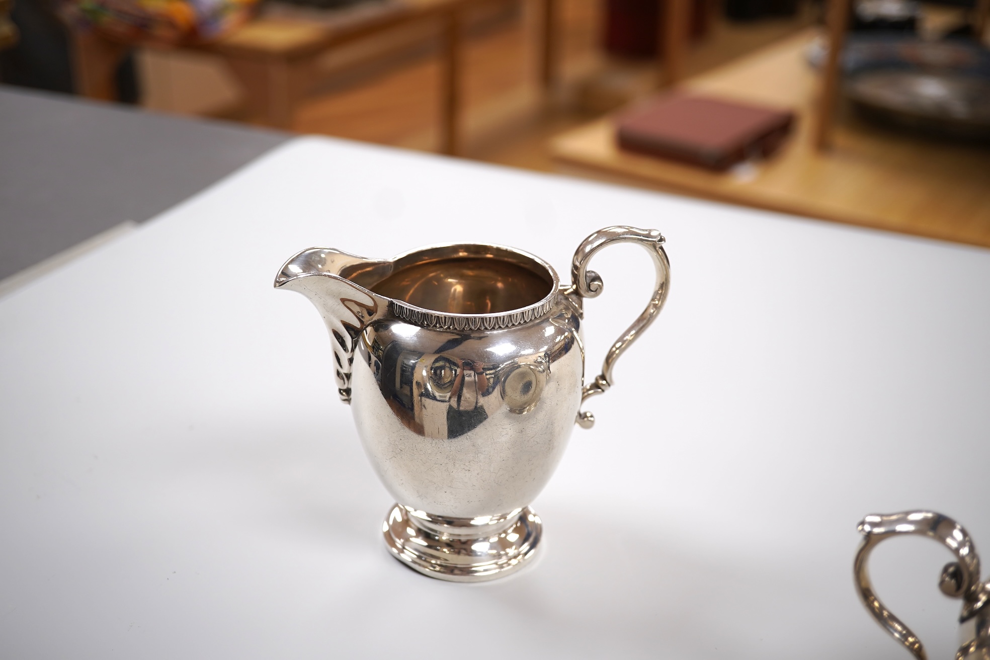 A George V silver circular three piece tea set, with engraved initial, Fenton, Russell & Co Ltd, London, 1927, gross weight 32.4oz.